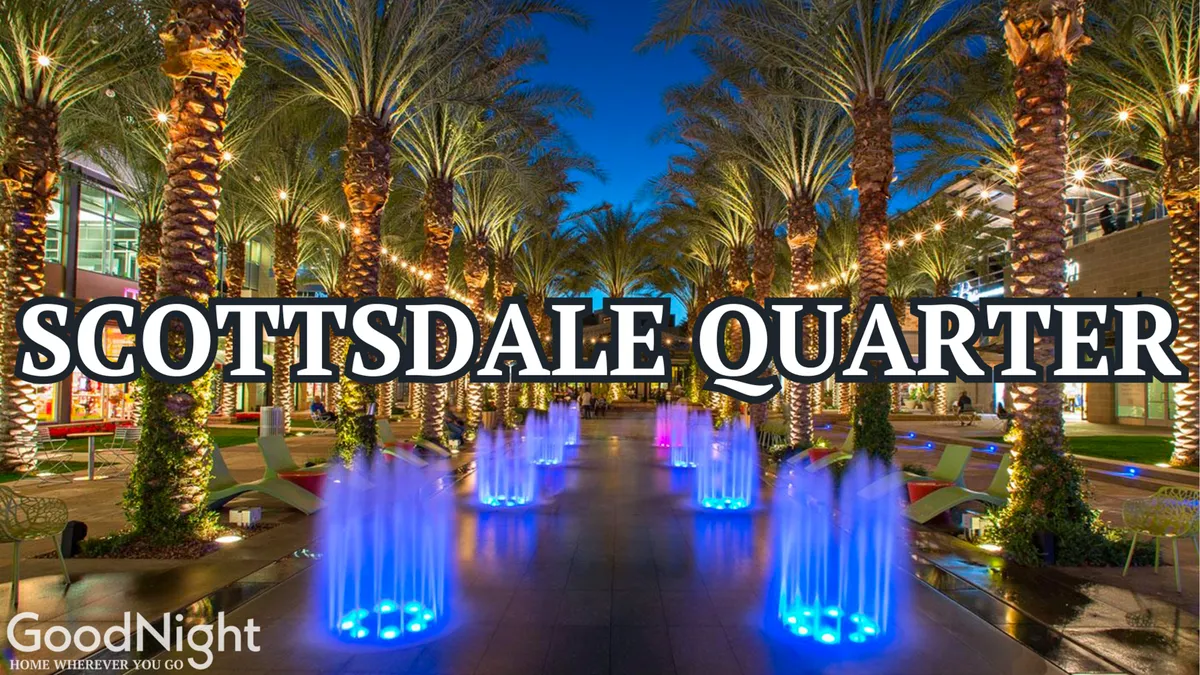 A lively, illuminated outdoor entertainment district featuring colorful fountains, palm trees, and a bustling walkway. The scene is festive, inviting, and hints at a vibrant nightlife with dining and community events.