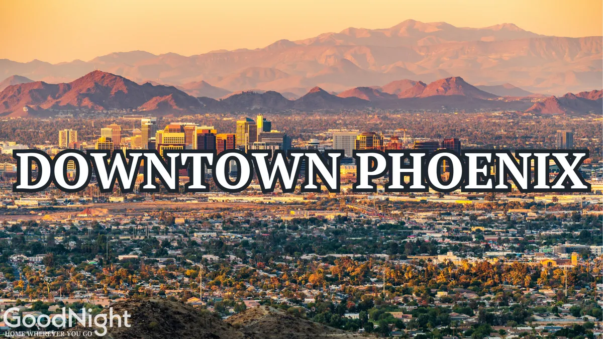 A dynamic cityscape view captures the downtown skyline with mountains in the background and residential neighborhoods below. The scene is energetic, modern, and urban, highlighting the property's close proximity to Phoenix's business and entertainment centers.